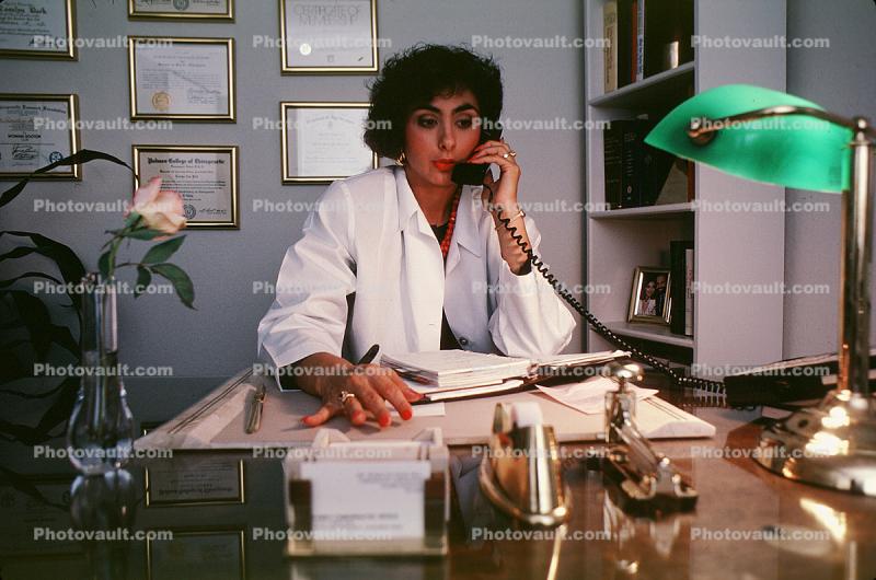 Female Doctor at her desk chatting on the phone