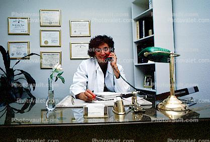 Female Doctor at her desk on the phone