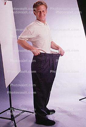 Man shows off weight loss, baggy pants