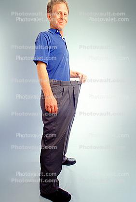 Man shows off weight loss, baggy pants