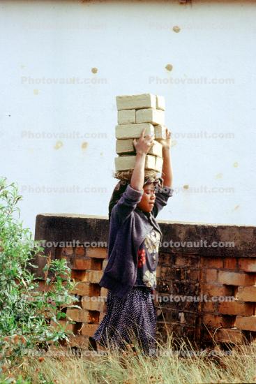 Woman carrying bricks, Ambostria