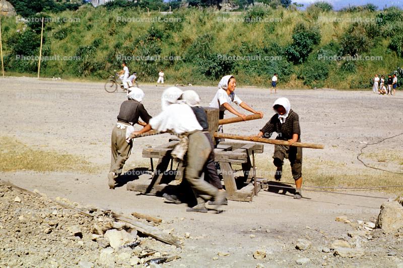 Turnstile, women, manual labor, water well, pump, Japan, 1940s
