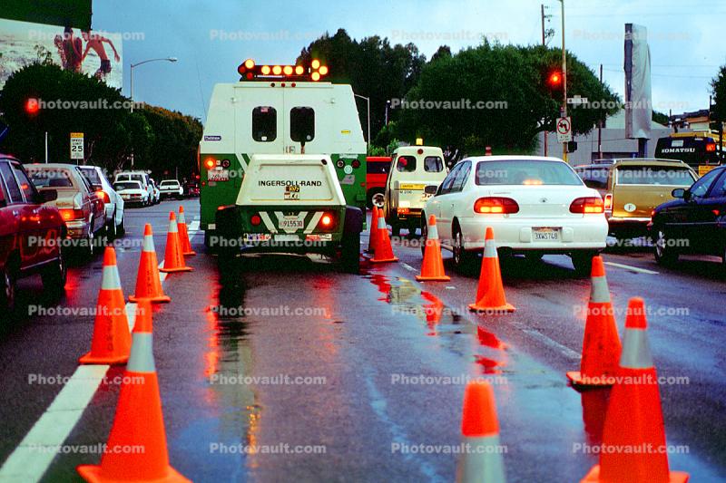 Traffic Cones, cars, rainy