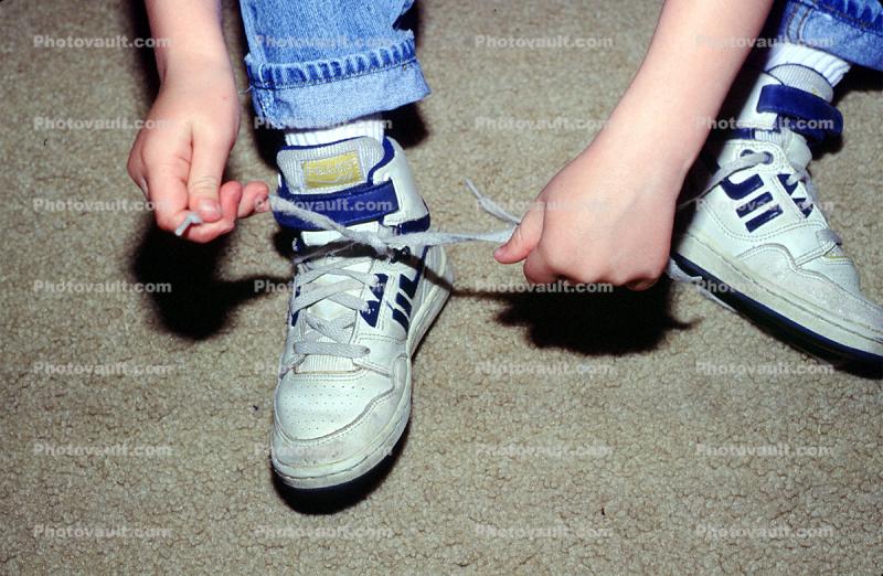 Boy Tying his shoes, shoestring