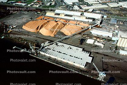 Conveyer Belt, dock, cranes, sawdust mounds, warehouse