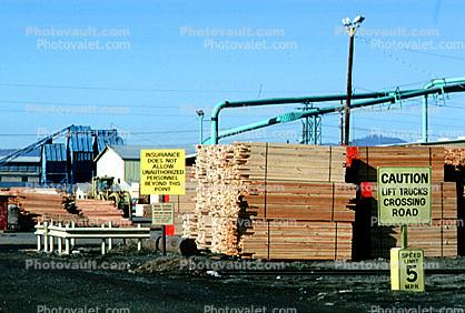 Lumber Yard, wood stacks, pipes, piping