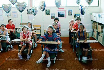 Students in a classroom, desks, class, girls, boys, smiles