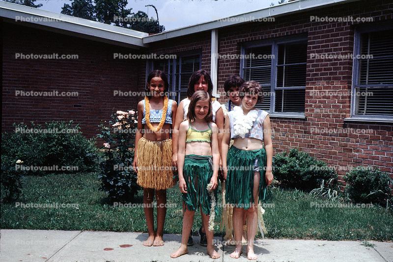 Girls, Grass Skirts, Lawn, Brick Building, Hawaii Day, smiles, smiling, 1960s
