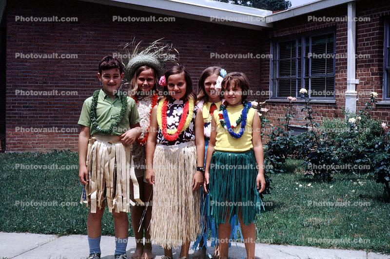Hawaii Day, Girls, Grass Skirts, Lawn, Brick Building, smiles, smiling, 1960s
