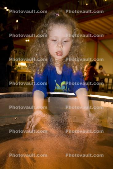 Girl playing with Sand, hands-on exhibit, touch