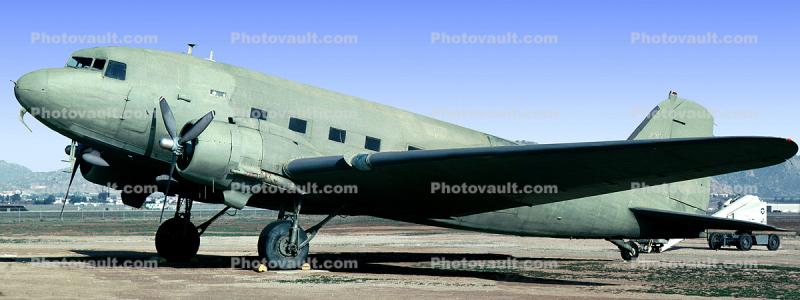 A C-47 at rest on the ground,,,,,,,,,,,,,j