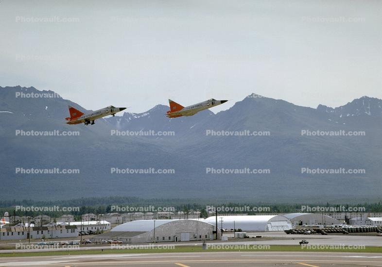 F-102 take-off, Elmendorf AFB, Quonset huts, USAF, mountains