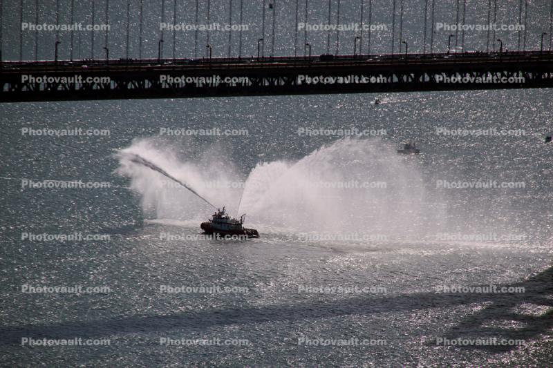 Fireboat Spraying water, bridge shadow
