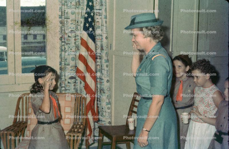 Brownie salutues a Girl Scout leader, 1950s