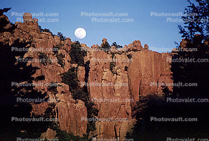 Moon over a rock cliff