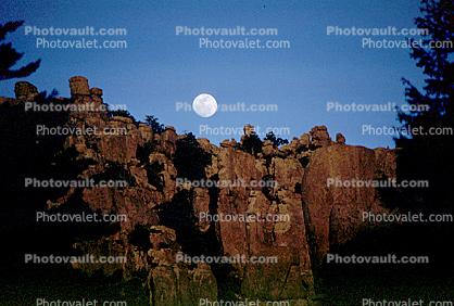 Moon over a rock cliff