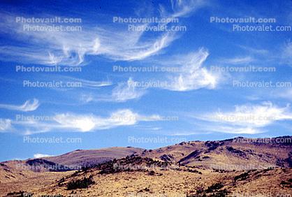 Whispy Clouds over a Barren Landscape, hills, mountains