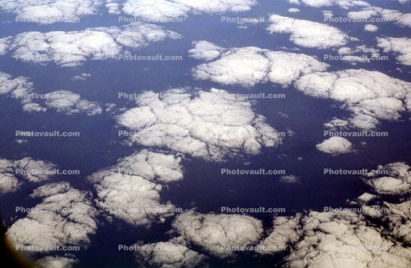Pancakes floating in the sky, flying over the midwest USA during the winter, daytime, daylight