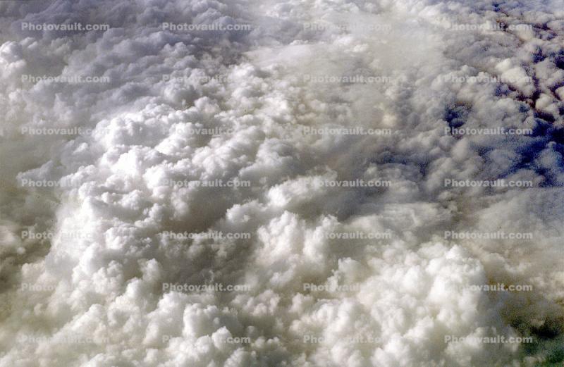 Cushiony fluffy clouds, flying over the midwest USA during the winter, daytime, daylight