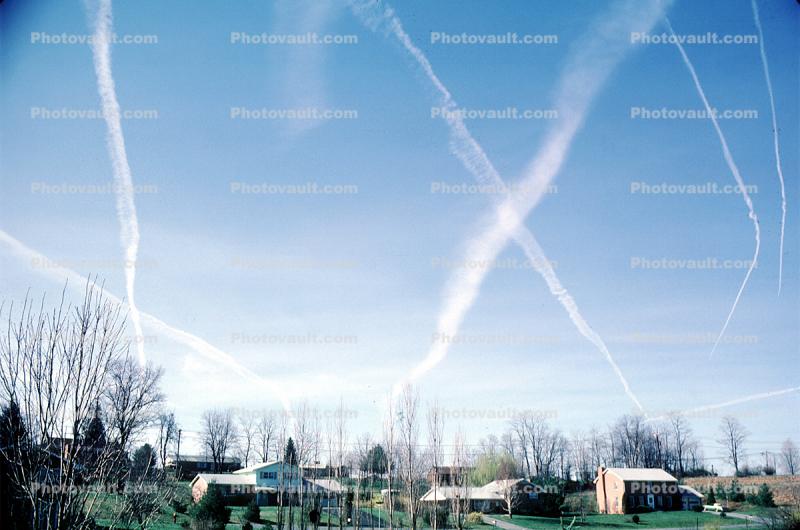 Intersection of contrails, daytime, daylight, homes, houses