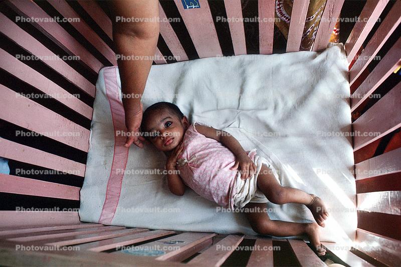 Girl in a crib, newborn