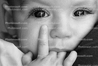 the tears in the eye, face, nose, hand, fingers, child