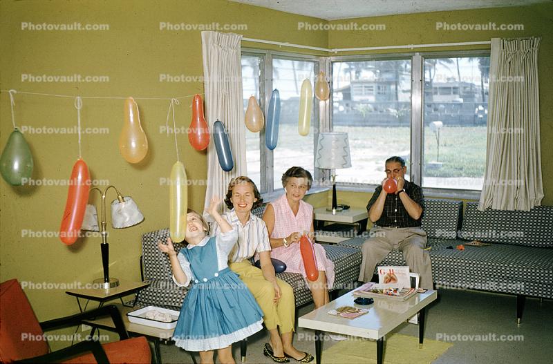 Birthday party girl, sofa, balloons, table, fun, funny, smiles, 1960s