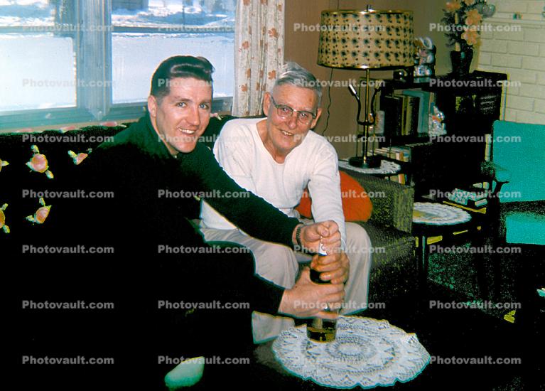 two men opening a bottle of chamagne, 1960s