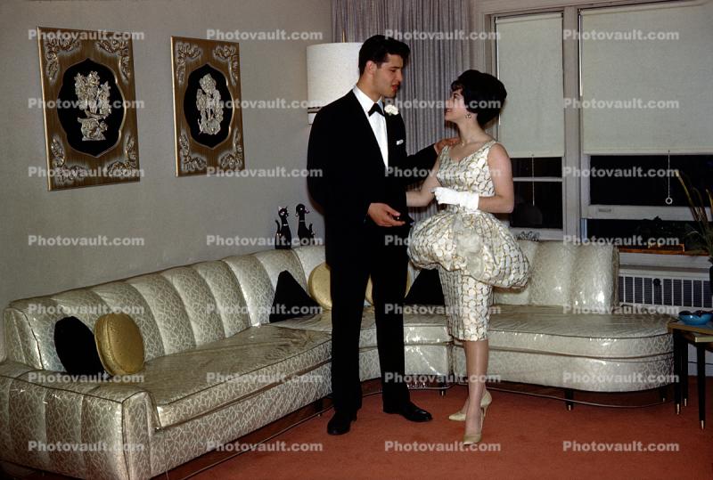 Man and Woman, Sofa with plastic cover, bizarre dress, gloves, formal, 1960s