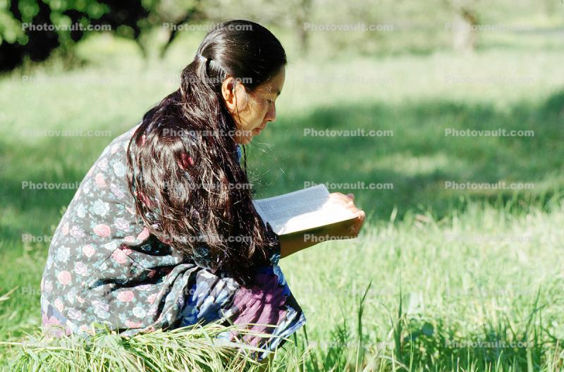 Woman Reading a Book Outdoors
