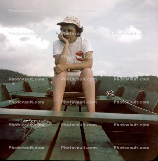 Woman, Sits and Thinks, and sometimes she just sits, rowboat, 1950s