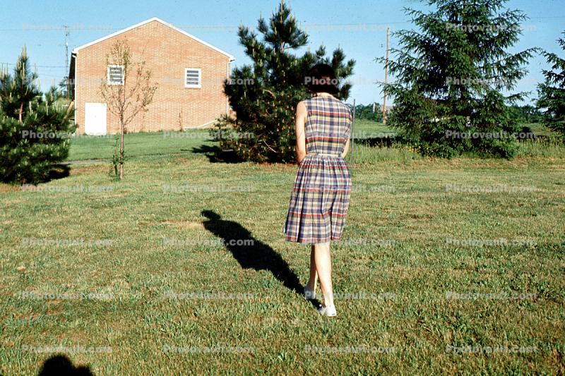 Woman Walking slowly, shadow, dress, lawn, Montreal, 1950s