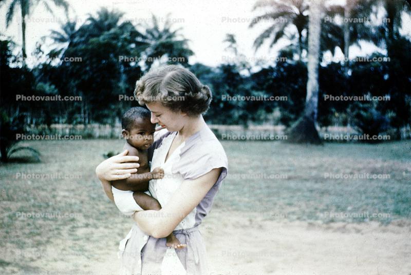 Missionary Woman Holds Baby, 1940s
