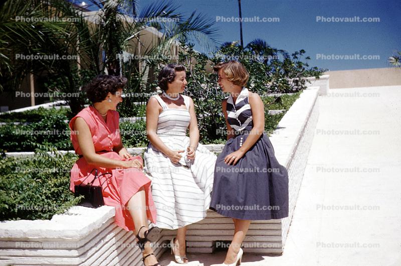 Women, sitting, chatting, dresses, 1950s