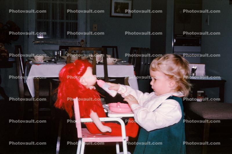 Girl Bottle Feeding her redhead doll, Toddler, 1950s