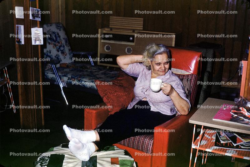 Woman, Recliner Chair, female, drinking tea, socks, pants, living room, 1950s
