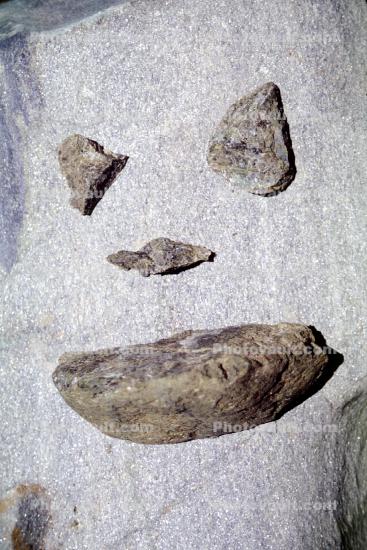 stone face with stone lips, pareidolia
