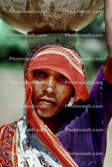 Woman carrying a large bowel on her head, Boral Village, Gujarat