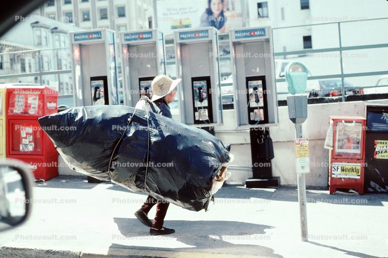 Chinese Woman with a huge load of Recyclables, Phone Booth, Parking Meter