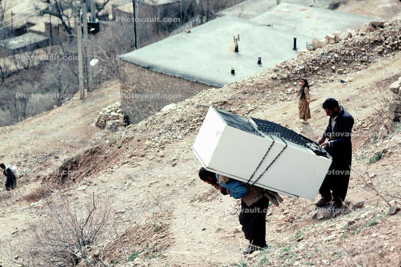 Man Carries a Refrigerator on his Back, Kamale Iran