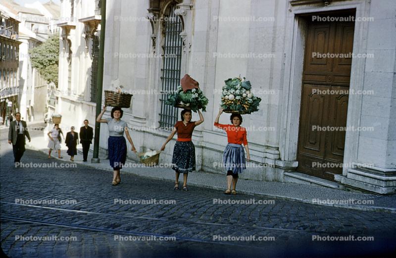 Women carrying vegetables, street, road, cobblestone, Lisbon, 1950s