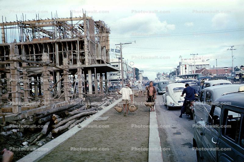 building construction, sidewalk, cars, Bangkok, Thailand, October 1962, 1960s
