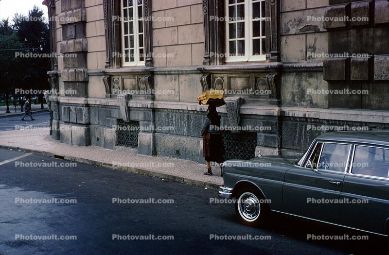 Woman walking, sidewalk, car, building, Lisbon Portugal, October 1966