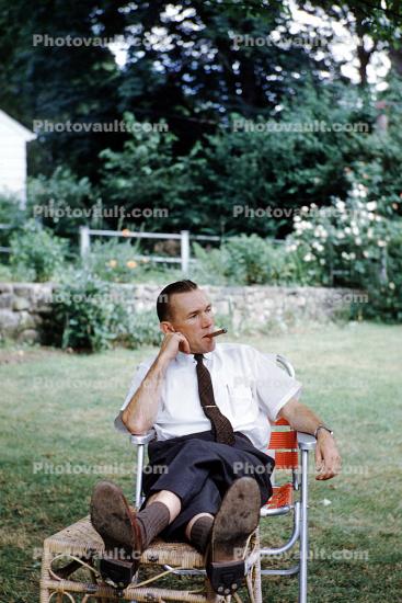 cigar smoking, man, lounging, pants, shoes, tie, backyard, 1950s