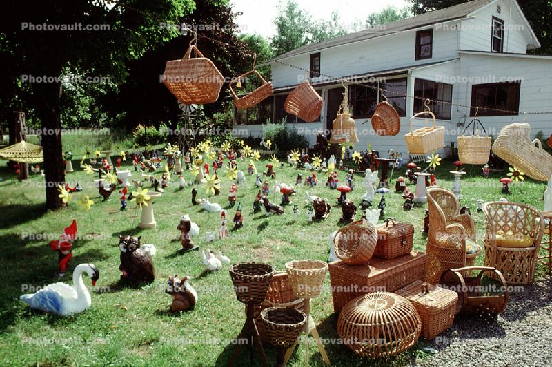 frontyard full of figurines, elfs, cats, mother goose, front yard, hammock, home, house, baskets