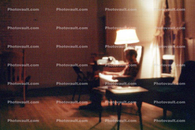 Lamp, chair, man reading, Burklyn Hall Burke, Vermont, 1978, 1970s
