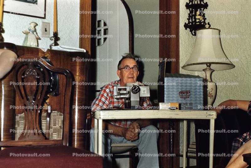 Man with a Project0r, slide show, lamp, table, 1950s