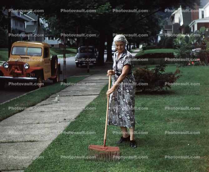 Grandma Racking Leaves, frontyard, 1950s
