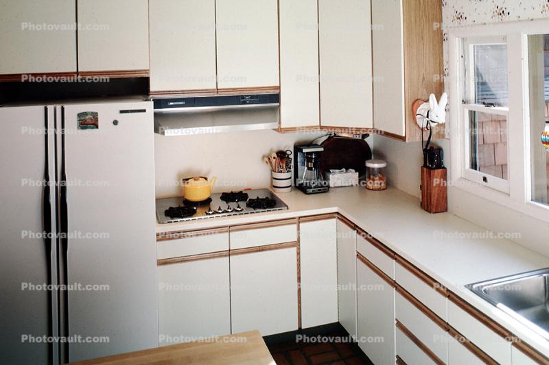 Kitchen sink, gas stove, refrigerator, counters, window