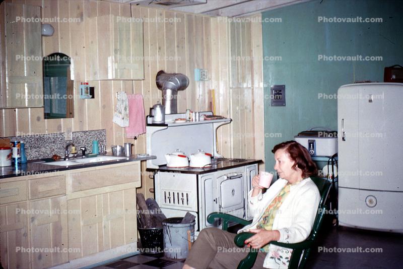 Woman in a Rocking Chair, drinking coffee, Wood Burning Stove, Sink, 1940s